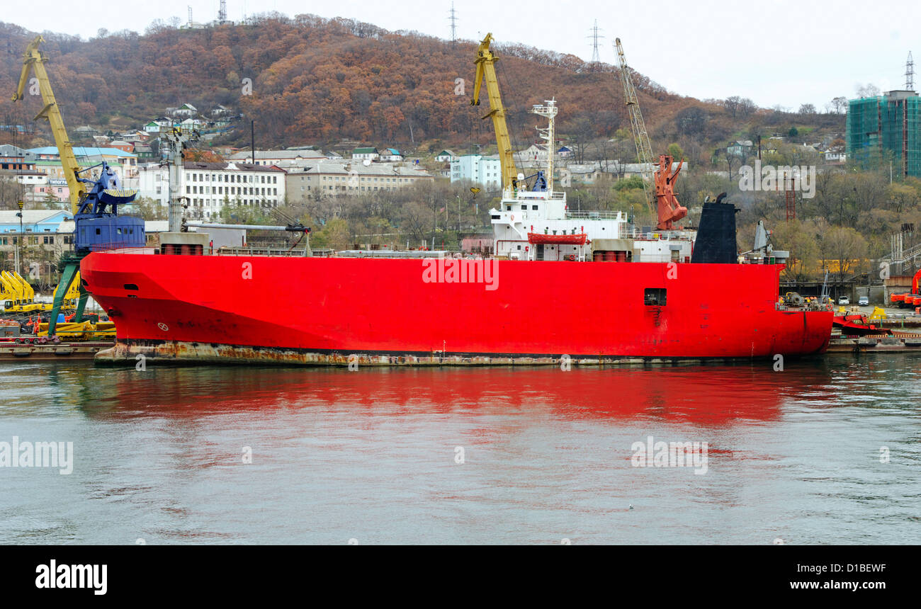 Ro-ro nave merci sotto lo scarico di costruzione di apparecchiature pesanti al porto Foto Stock