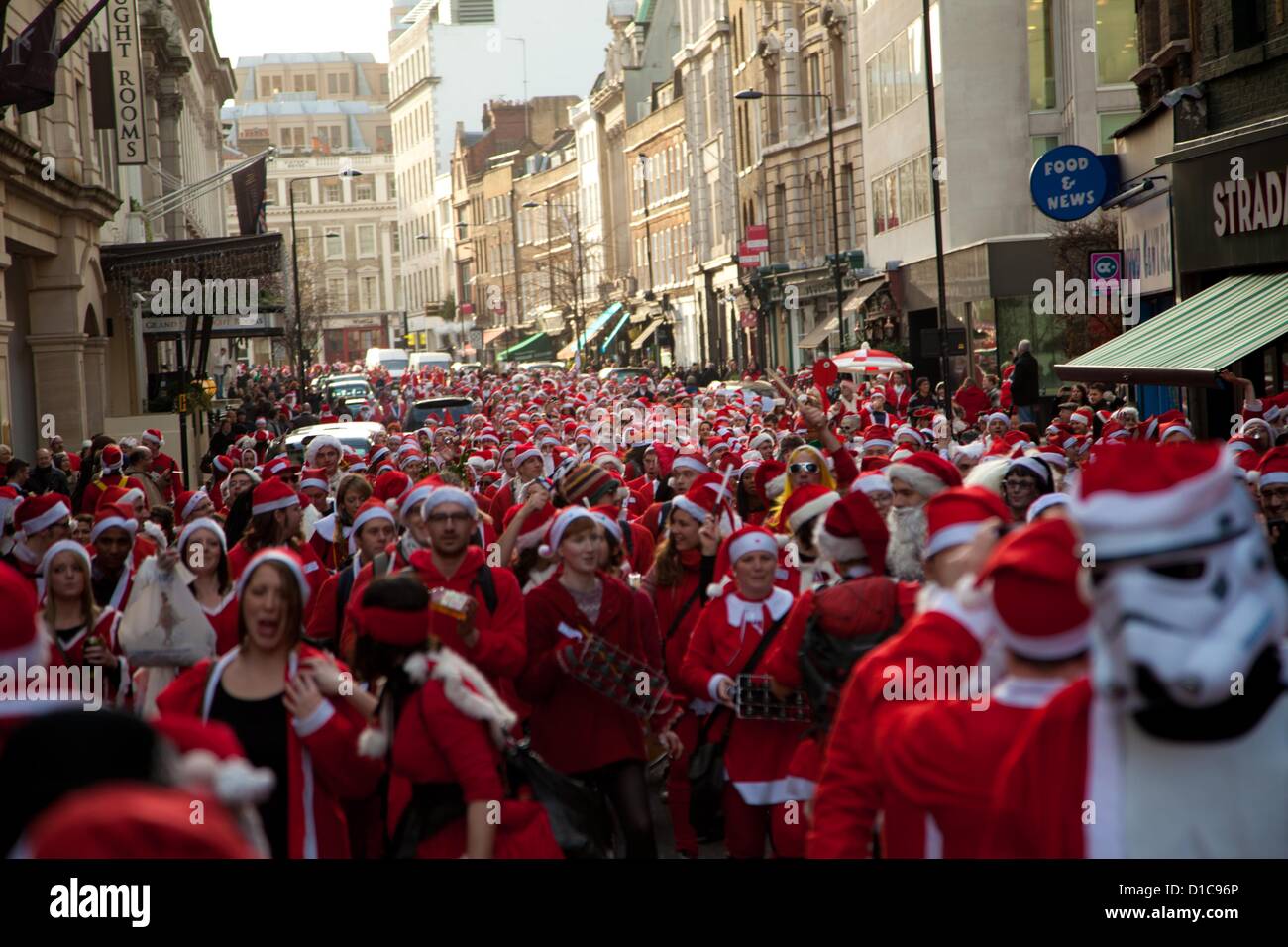 Londra, Regno Unito. Il 15 dicembre 2012 il grande raduno di Santa Con si sposta in alto grande Queen St verso Holborn guidato da una banda di samba. Credito: Nelson pereira / Alamy Live News Foto Stock