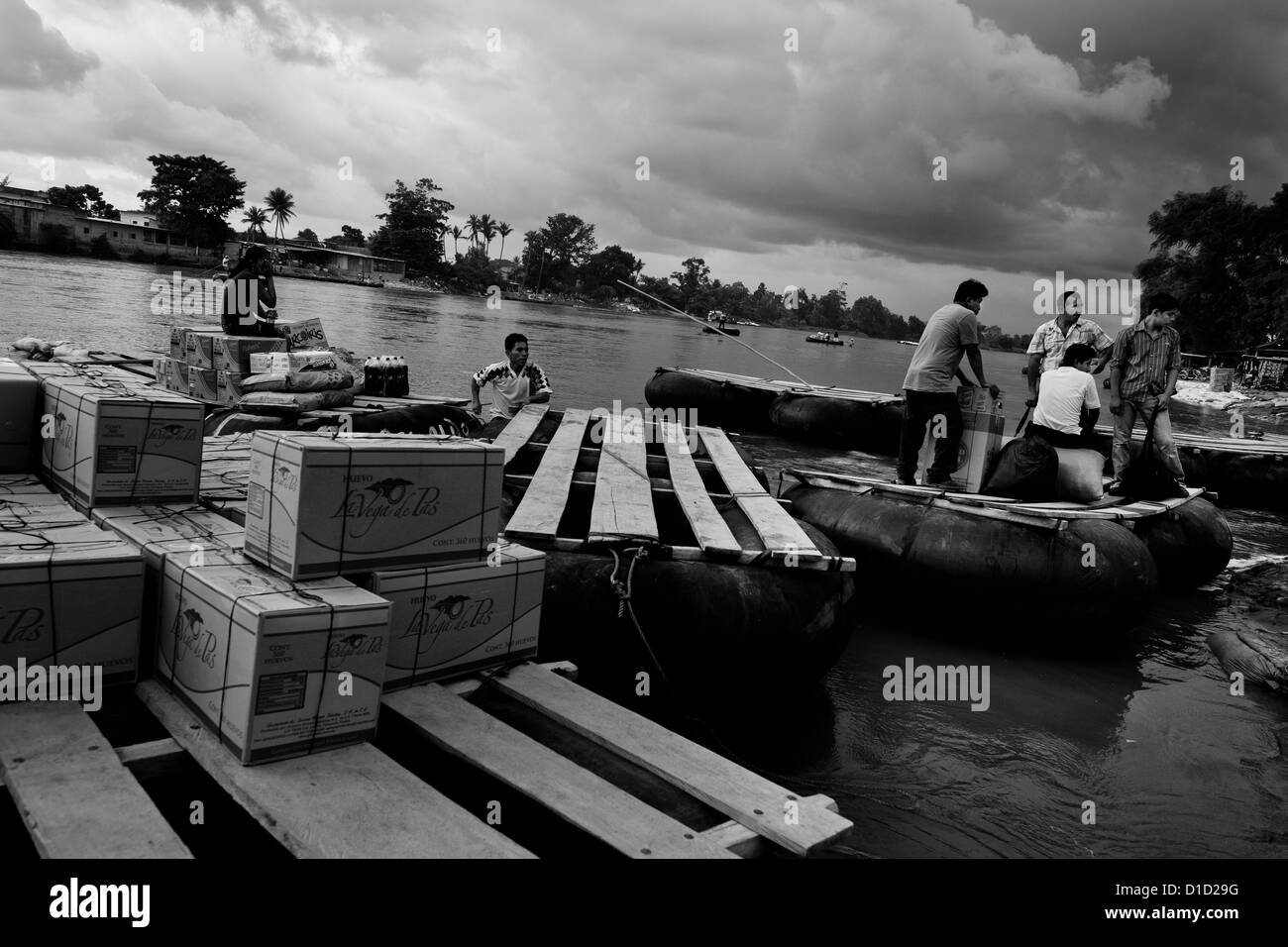 Scatole di contrabbando di merci sono caricati sul tubo interno zattere ancorato sulla riva del fiume suchiate in Tecún Umán, guatemala. Foto Stock