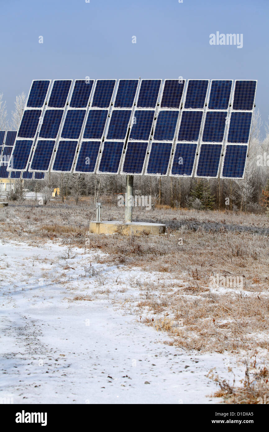 Grandi pannelli solari con gelo invernale e ghiaccioli appeso, energia alternativa, scelta ambientale, Foto Stock