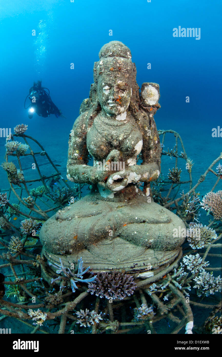 Statua di Shiva al reef artificiale di formazioni con subacqueo in background nei pressi di Pemuteran, Bali, Indonesia, Oceano Pacifico Foto Stock