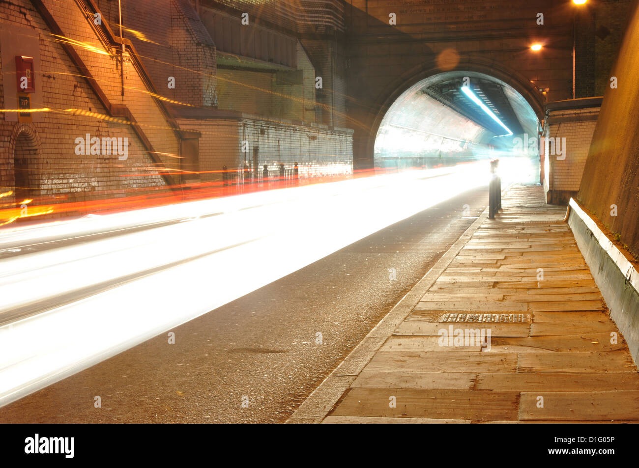Fari di automobile attraverso un tunnel Foto Stock