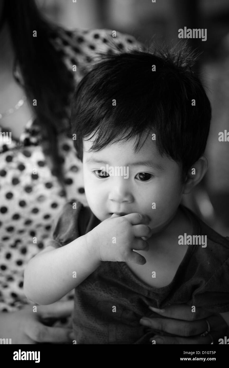 Una bambina è tenuto da sua madre in un mercato in Ninh Binh provence del  Vietnam Foto stock - Alamy