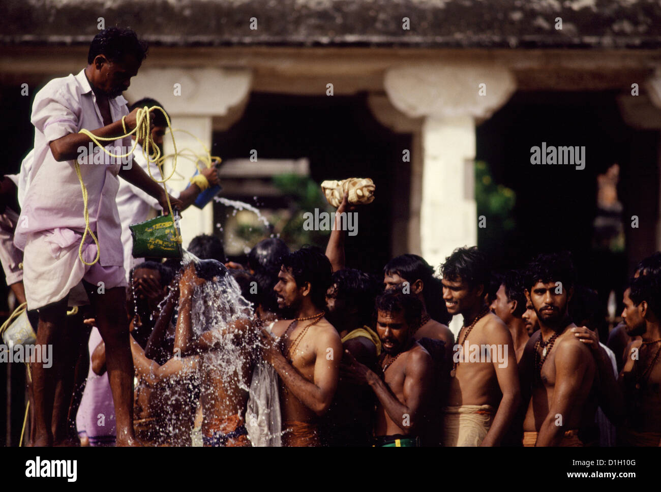 Devoti indiani durante il bagno rituale nel Tempio Ramanathaswamy Rameshwaram in India del Sud Foto Stock