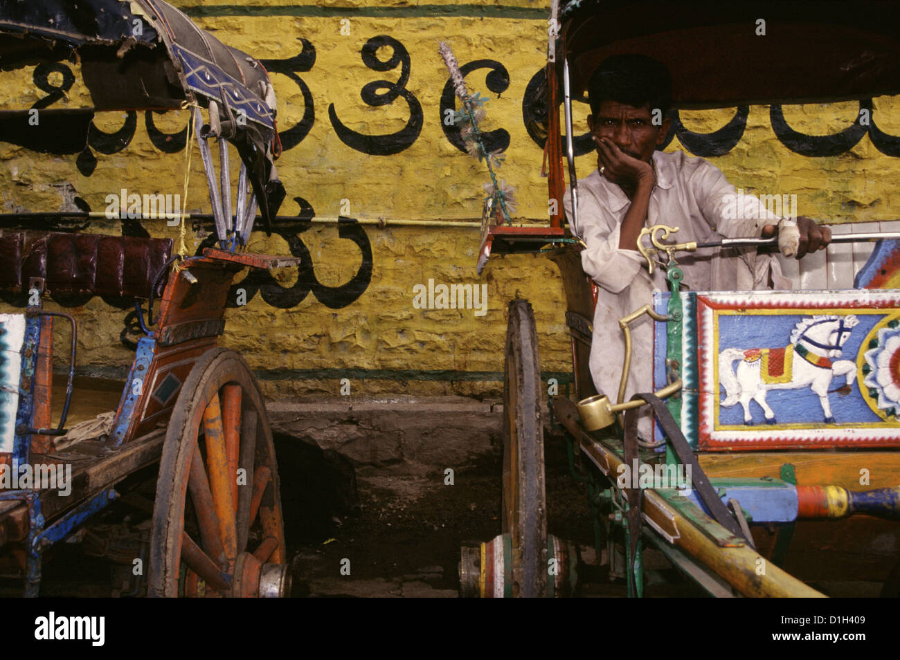 Un uomo in un carro di legno decorato, noto anche come tonga o tanga, a Bijapur, Karnataka, India Foto Stock