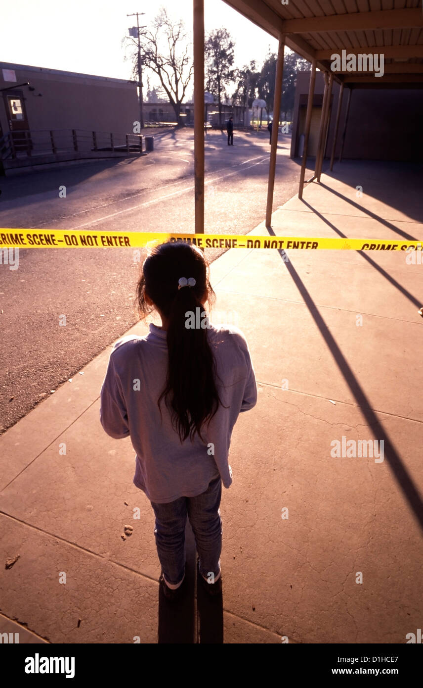 Giovane studente orologi come la polizia cerca i motivi di Cleveland Scuola elementare dopo un pistolero ucciso cinque feriti e 29 studenti in Stockton, CA. Foto Stock