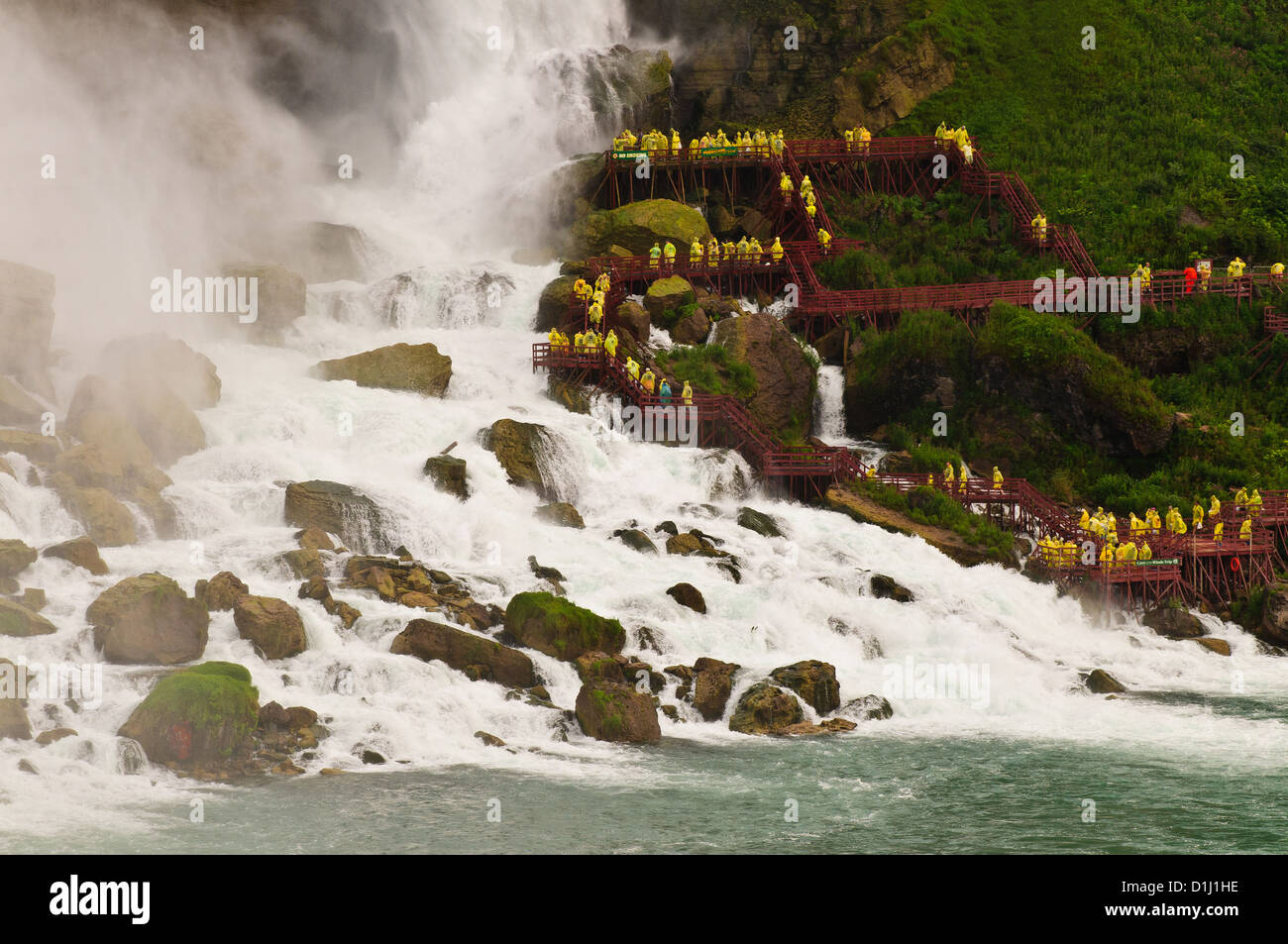 I turisti navigare le passerelle accanto al lato Americano delle Cascate del Niagara Foto Stock