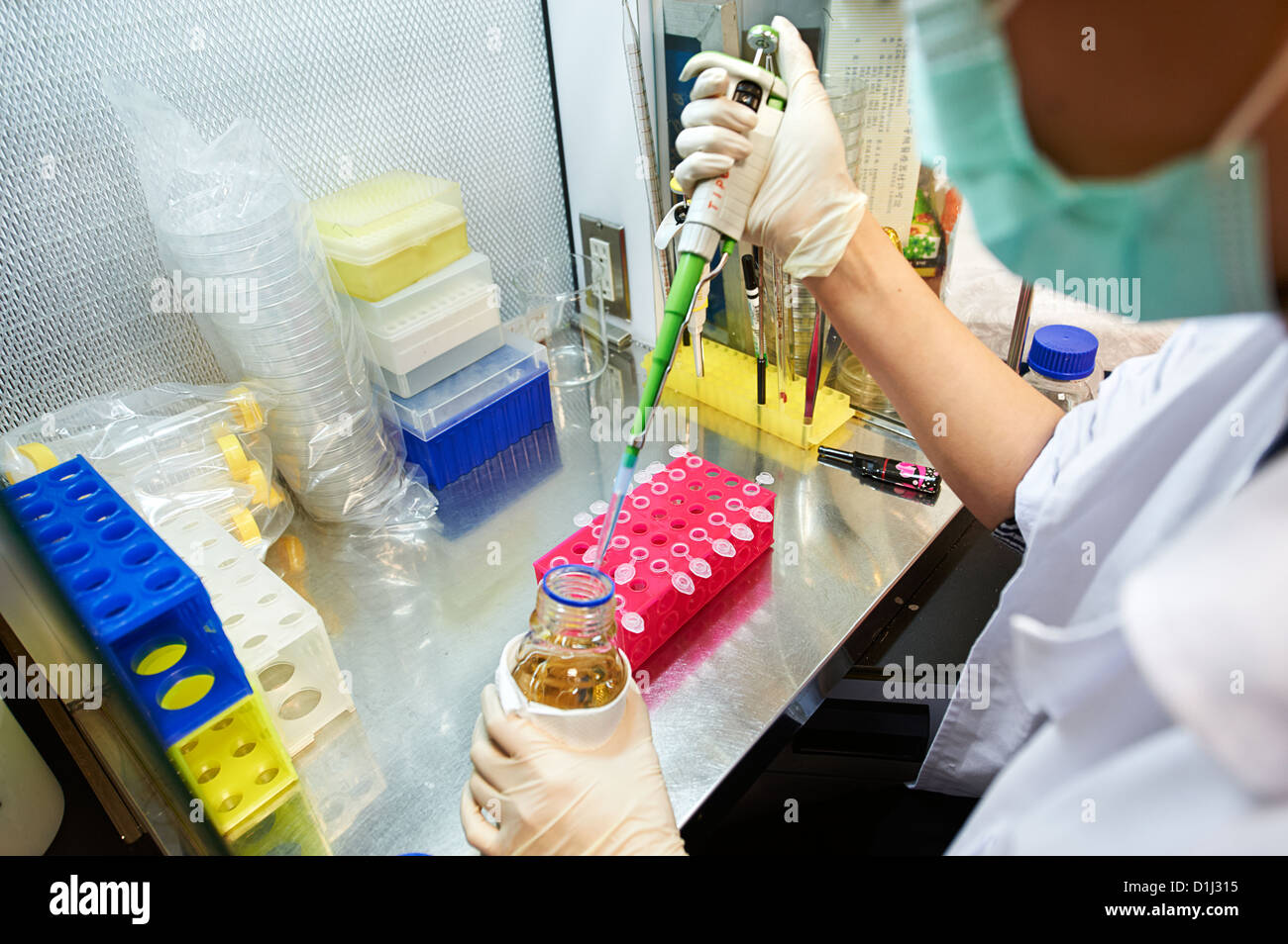 Un lavoratore di laboratorio test di riempimento tubi in corrispondenza di un tessile research lab e stabilimento Foto Stock
