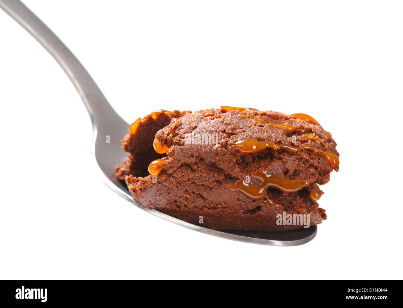 Salsa al cioccolato gelato sul cucchiaio Foto Stock