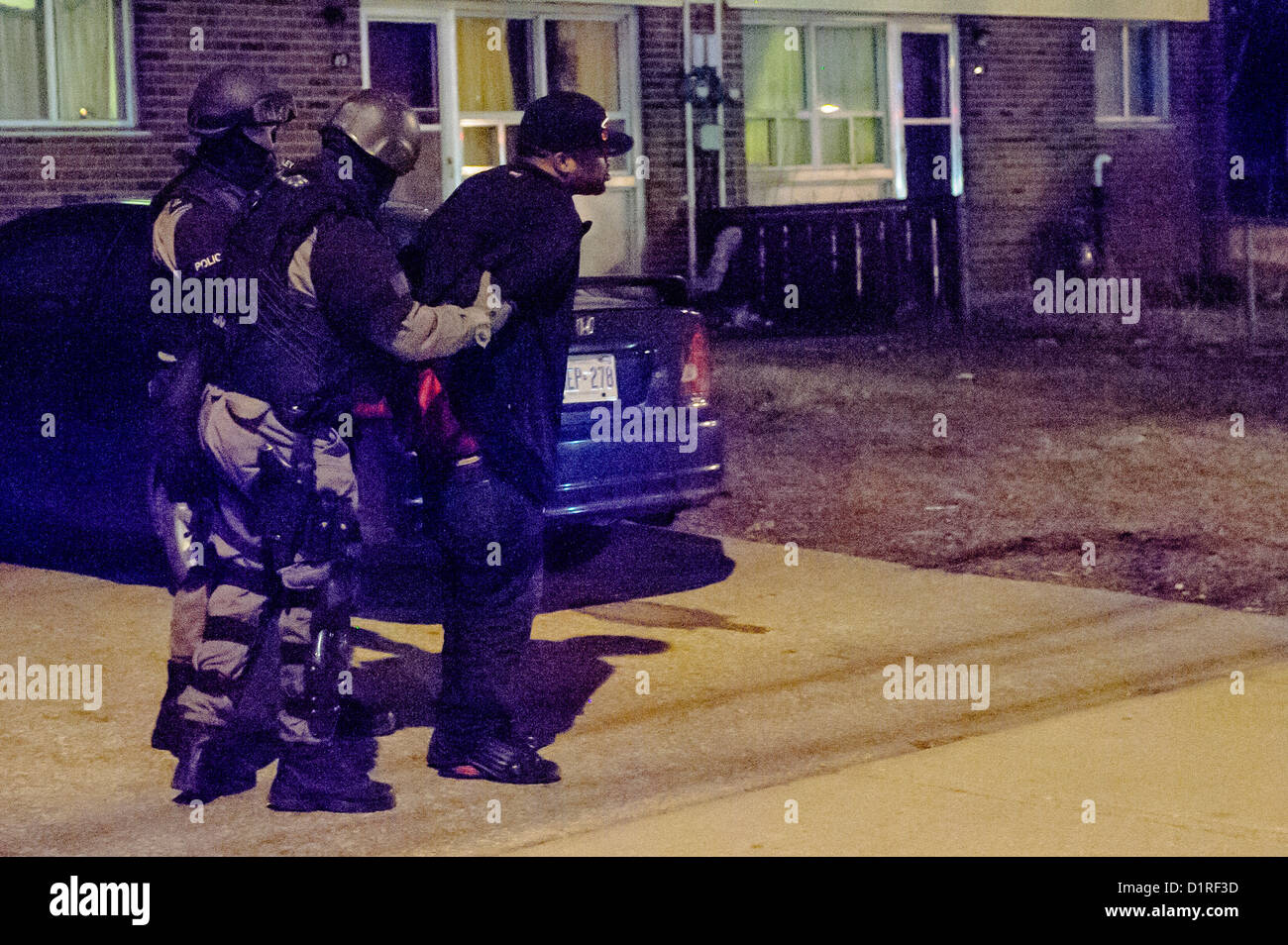 Armate pesantemente i membri della polizia di Toronto di eseguire un mandato di perquisizione arresto di più di una dozzina di persone Foto Stock