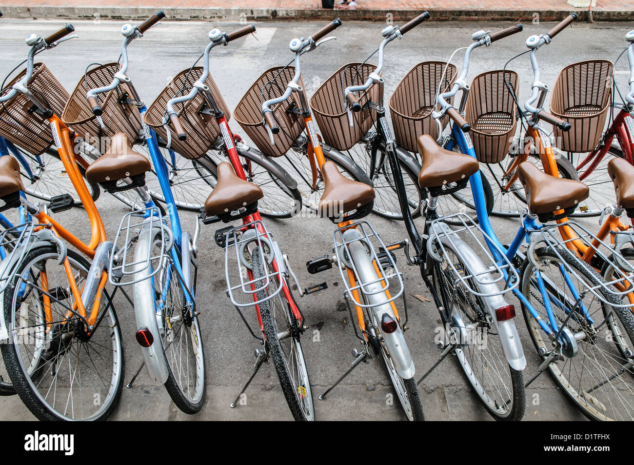 Noleggio biciclette Luang Prabang Laos // LUANG PRABANG, Laos - le biciclette sono allineate per il noleggio lungo una strada a Luang Prabang, una città patrimonio dell'umanità dell'UNESCO nel Laos centro-settentrionale. L'ex capitale reale si trova alla confluenza dei fiumi Mekong e Nam Khan ed è conosciuta per la sua architettura ben conservata che unisce stili tradizionali del Laos e coloniali francesi. Il noleggio di biciclette è un'opzione di trasporto popolare per i visitatori che esplorano i numerosi templi buddisti, i mercati tradizionali e i quartieri storici della città. Luang Prabang servì come sede del Regno del Laos fino al 1975 e rimane Foto Stock