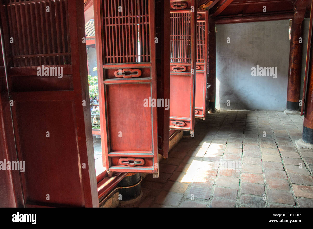 HANOI, Vietnam - porte pieghevoli in legno rosso decorate al Tempio della Letteratura di Hanoi. Il tempio fu costruito nel 1070 ed è uno dei numerosi templi del Vietnam dedicati a Confucio, saggi e studiosi. Foto Stock