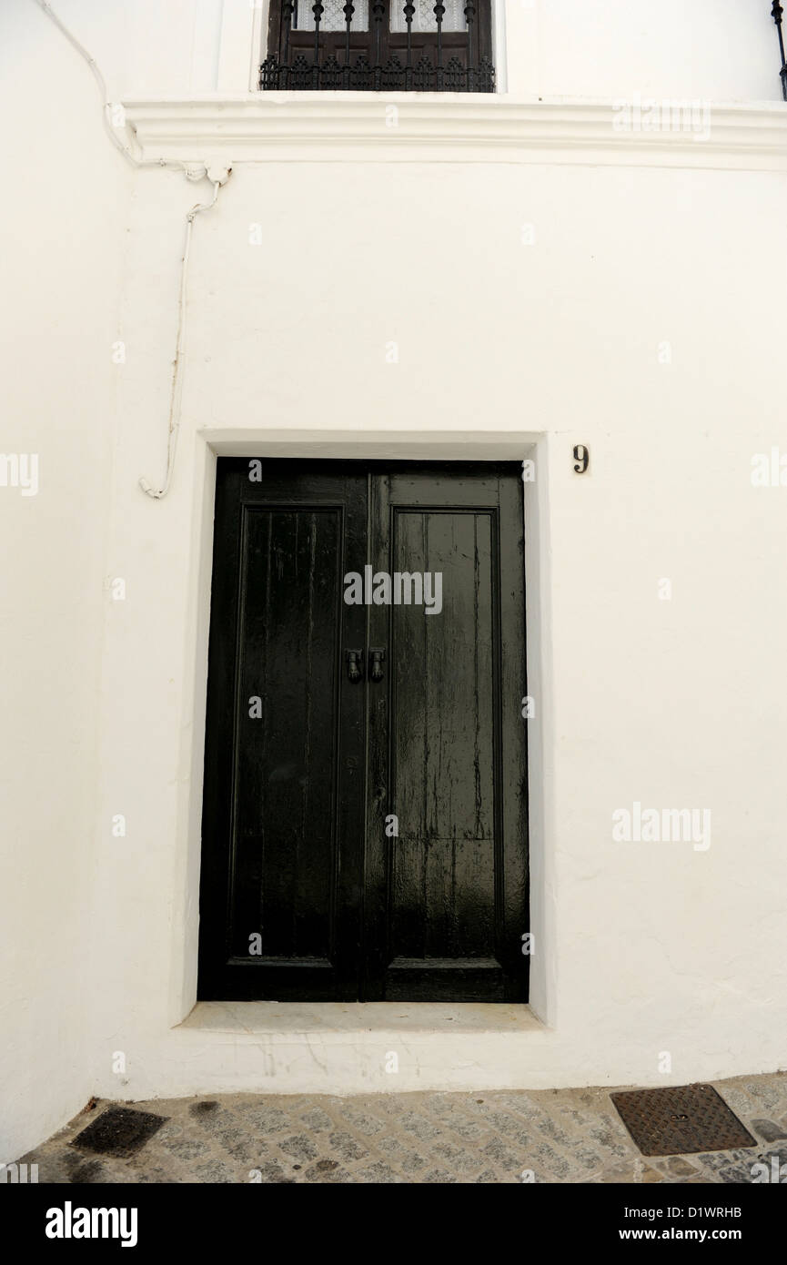 Vecchio nero porta di legno, numero 9, Vejer de la Frontera, uno dei Pueblos Blancos o bianche città dell'Andalusia, Spagna Foto Stock