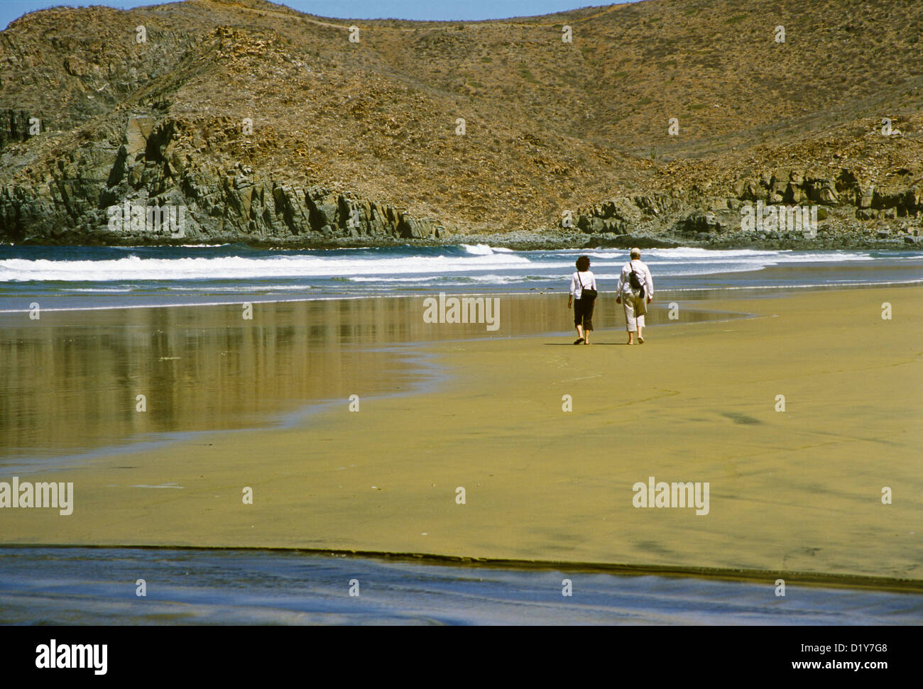 Due donne a piedi su di una spiaggia appartata vicino a Todos Santos, Baja, Messico Foto Stock