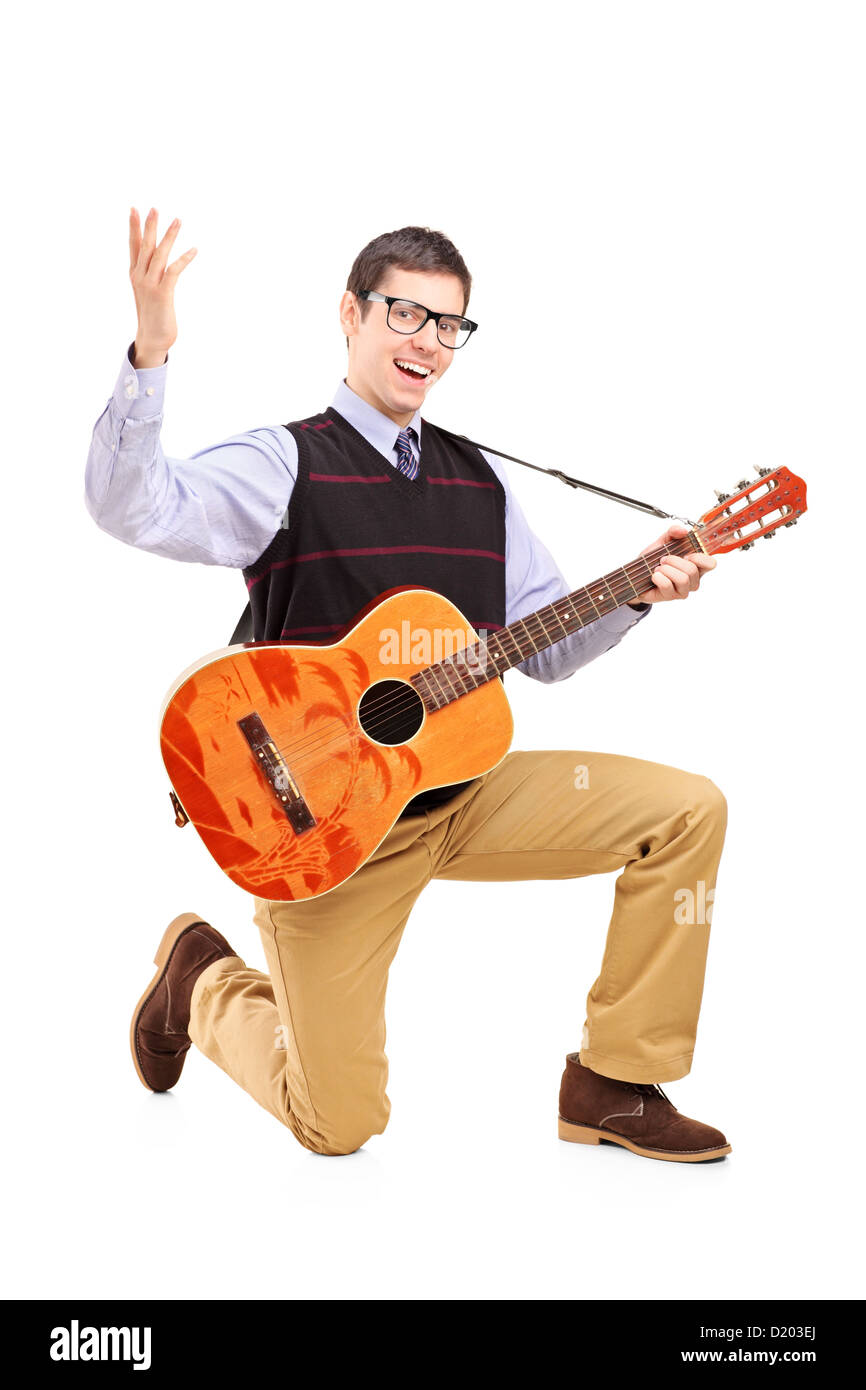 Un maschio felice di suonare una chitarra e canto isolato contro uno sfondo bianco Foto Stock
