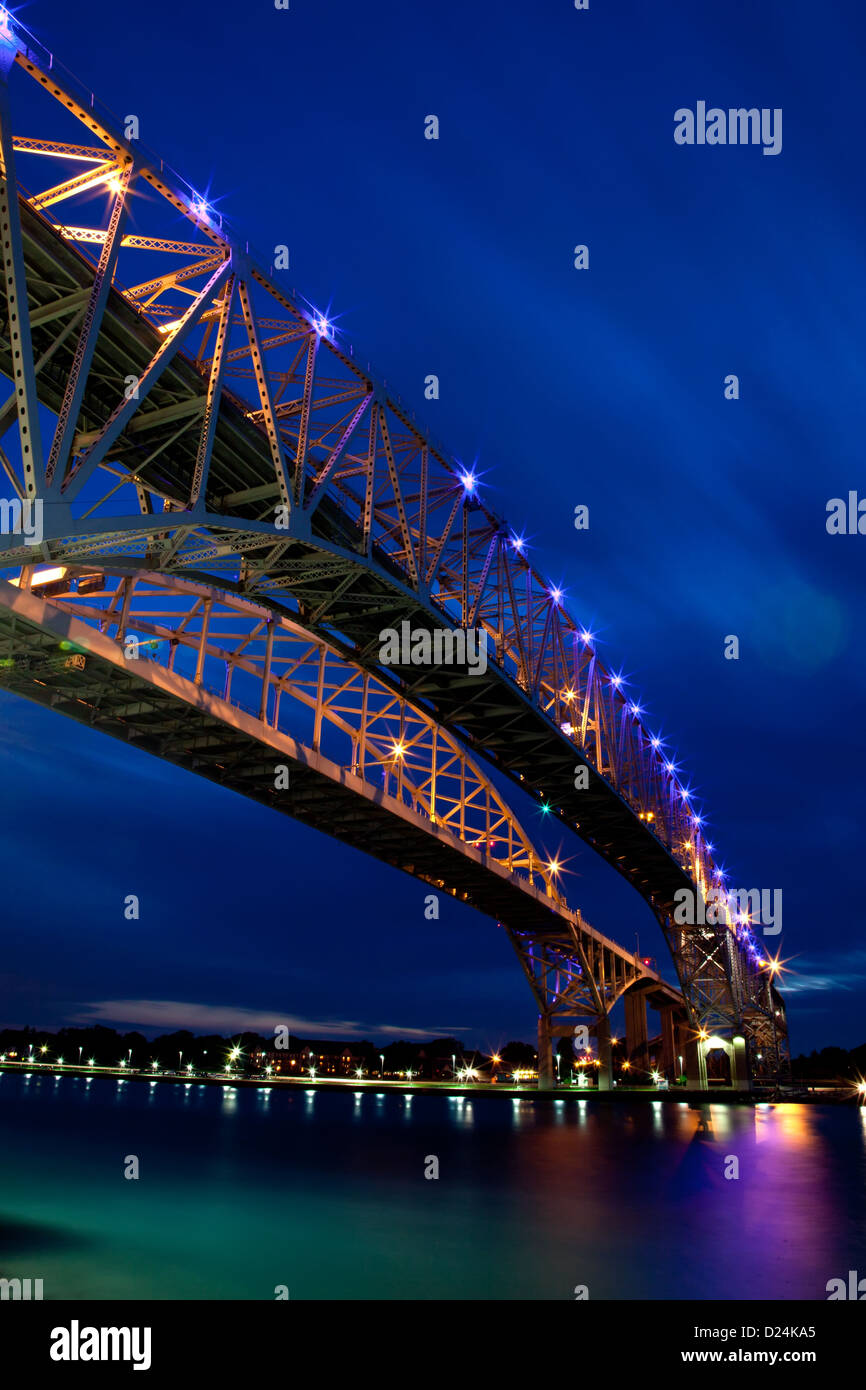 Un ponte che attraversa un ampio fiume shot di notte. Foto Stock