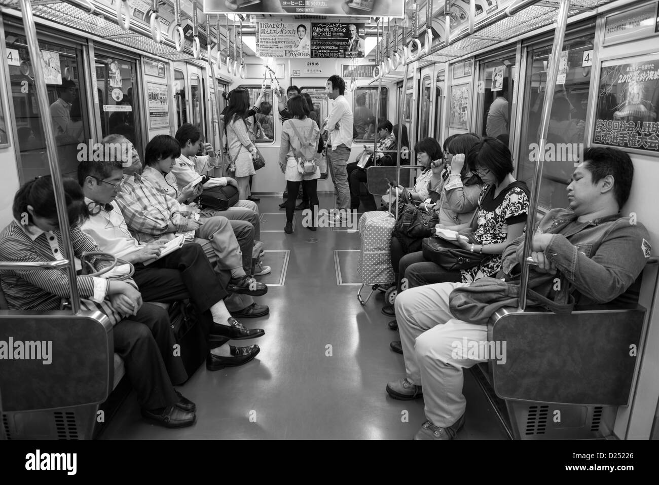 Pendolari a bordo di un Chuo Line treno della metropolitana di Osaka in Giappone Foto Stock