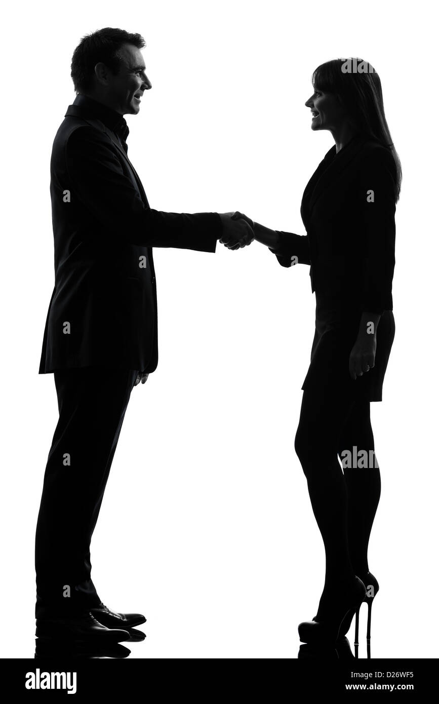 Una giovane donna uomo handshake in silhouette studio isolato su sfondo bianco Foto Stock