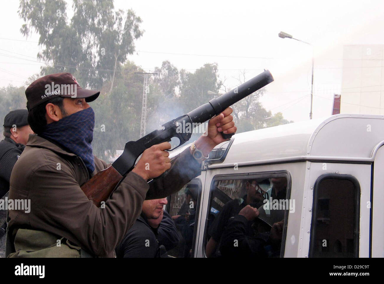 Ufficiali di polizia spara gas lacrimogeni shell per disperdere i dimostranti durante la manifestazione di protesta di Tehreek Mutasireen Khyber Agency contro esercito il funzionamento in Khyber agenzia a Peshawar press club il giovedì, 17 gennaio 2013. Foto Stock