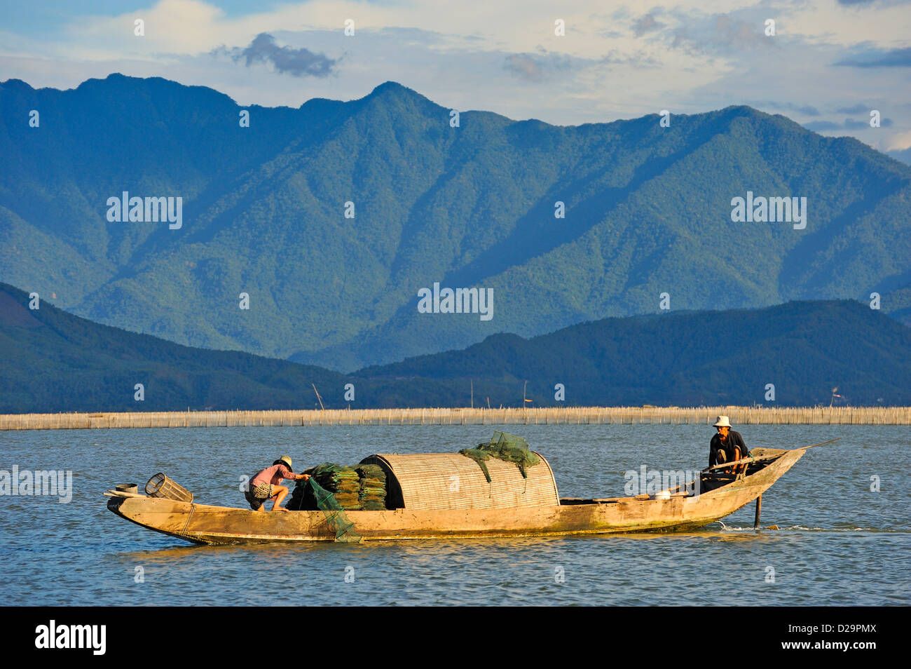 Paesaggio vietnamita con pescatori e ragazzi con trappole da pesca sul lago laguna di Phu Loc, provincia di Thua Thien-Hue Foto Stock