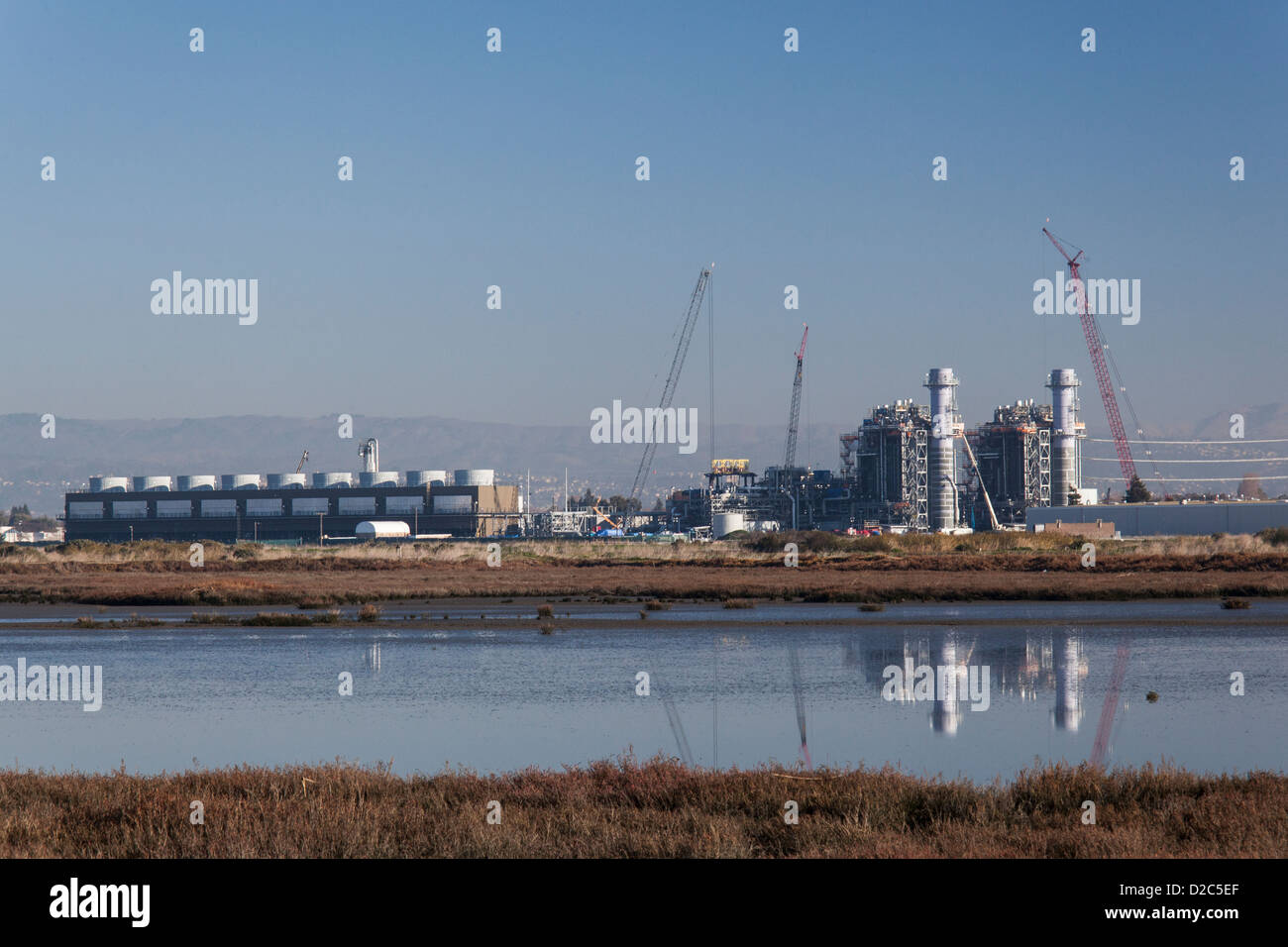 Impianto di alimentazione in costruzione in corrispondenza di un bordo di una palude salata e wetland Wildlife Refuge sulla Baia di San Francisco. Foto Stock