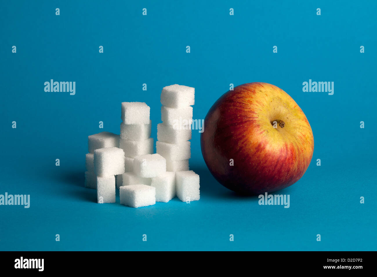 Il contrasto di Apple e i cubetti di zucchero Foto Stock