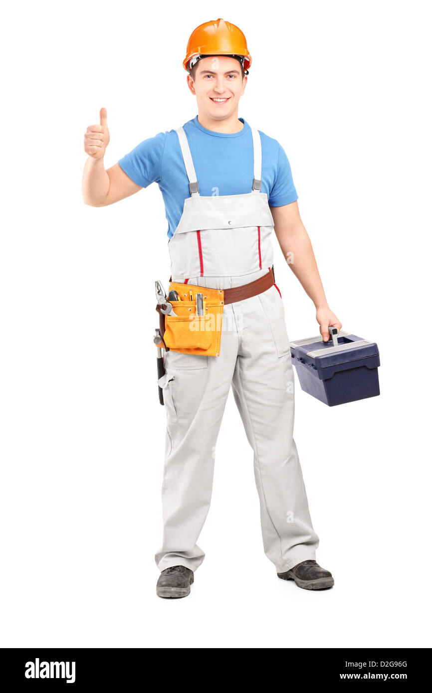 A piena lunghezza Ritratto di un lavoratore manuale tenendo un tool box e dando un pollice in alto isolato su sfondo bianco Foto Stock