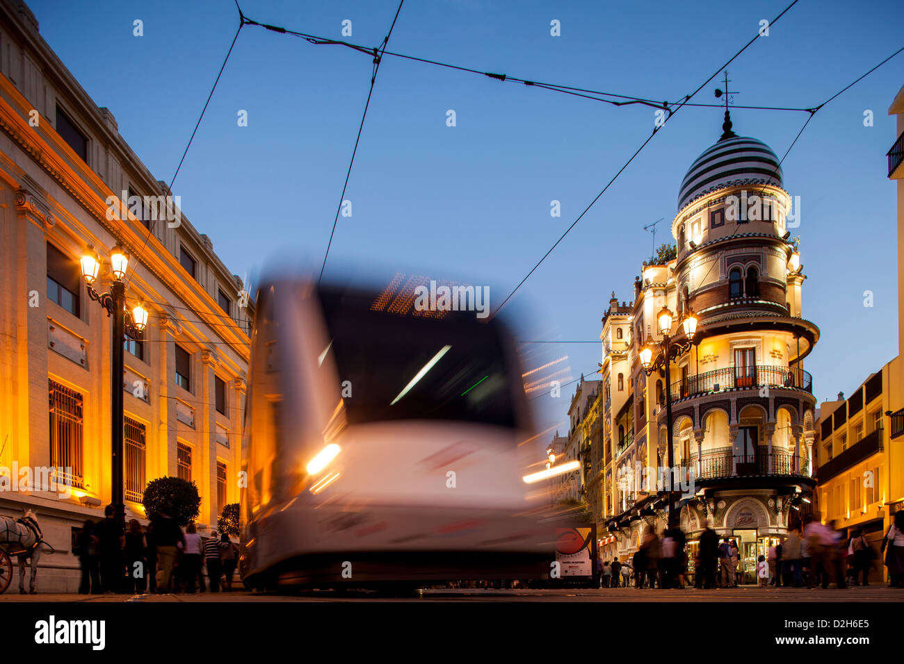 Siviglia, Spagna, un tram sulla Avenida de la Constitucion di sera Foto Stock