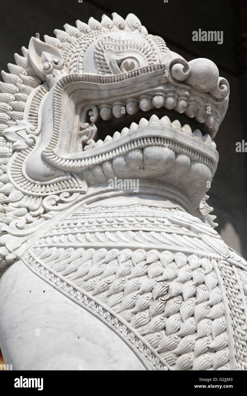 Questo feroce Drago in marmo custodisce un tempio thailandese ingresso Foto Stock