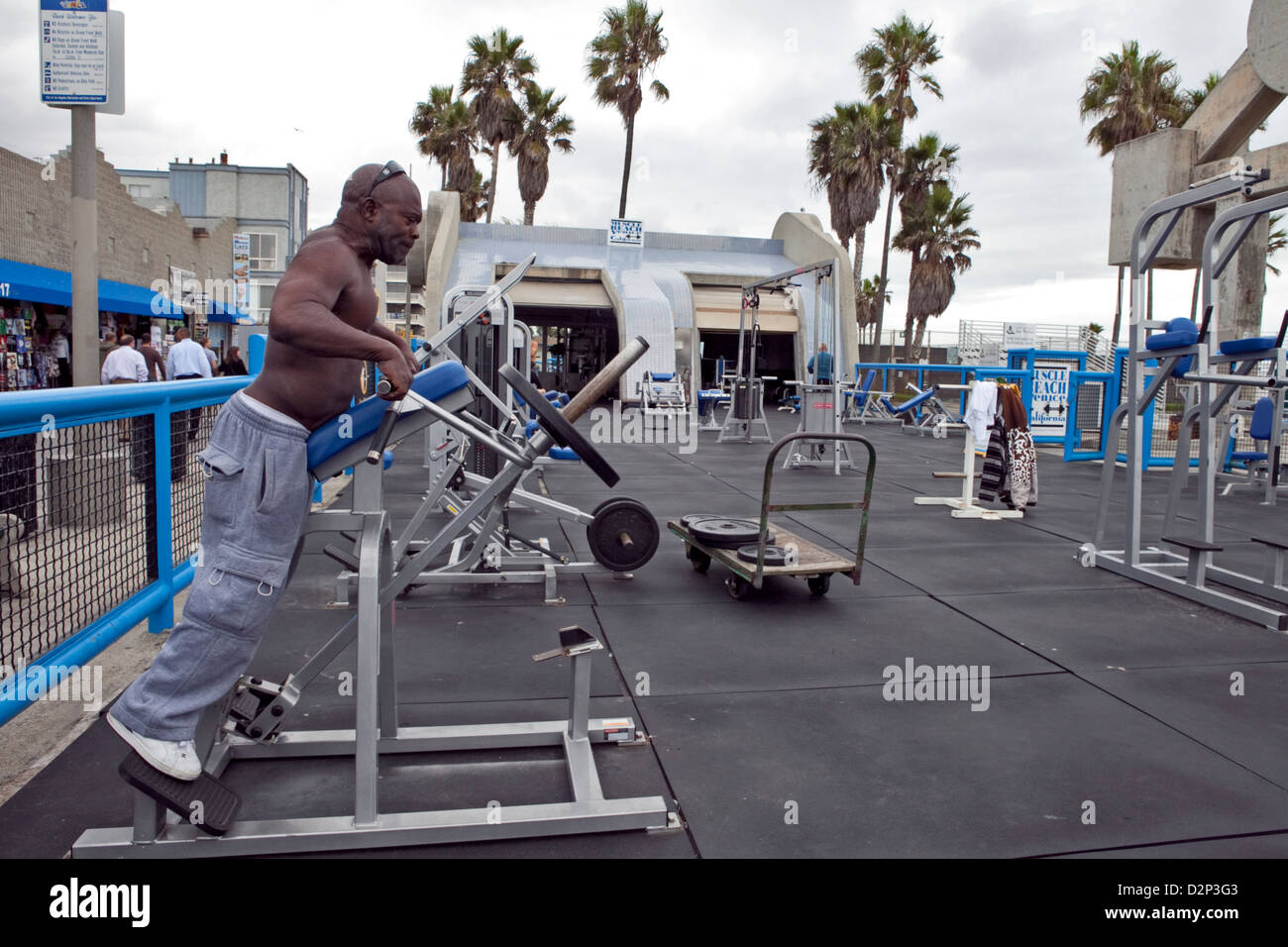 Un uomo che lavora fuori al muscolo palestra in spiaggia a Venice Beach, CALIFORNIA, STATI UNITI D'AMERICA Foto Stock