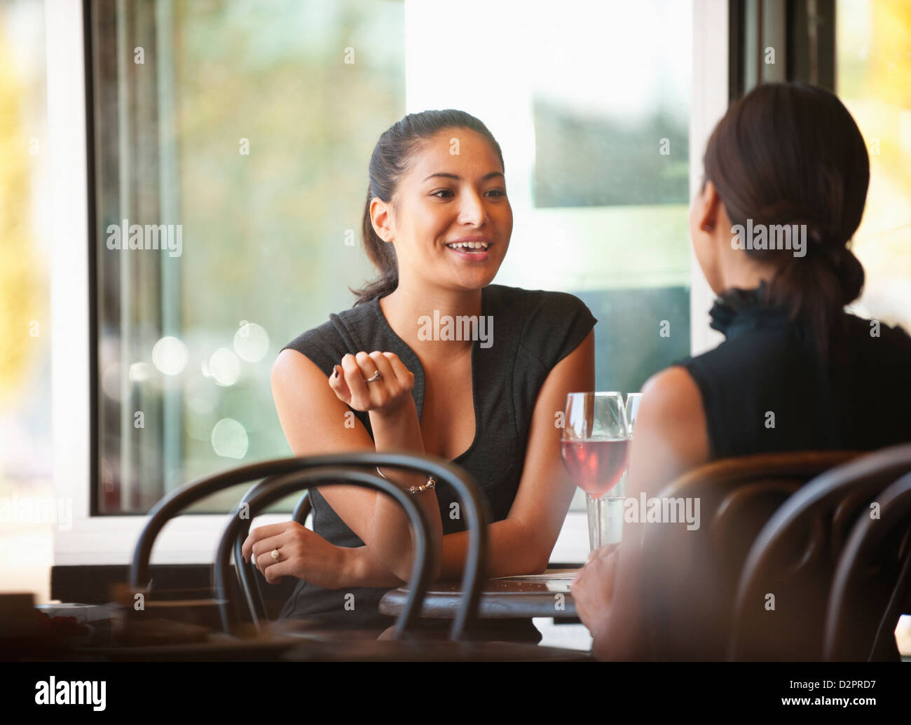 Amici asiatici seduti insieme in cafe Foto Stock