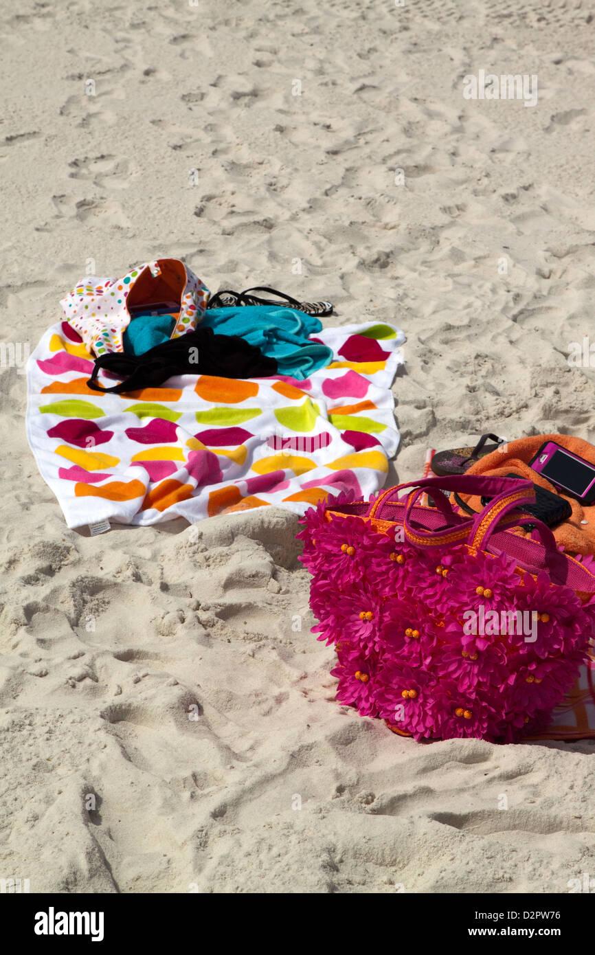 Asciugamani da spiaggia e accessori che giace sulla sabbia Foto Stock