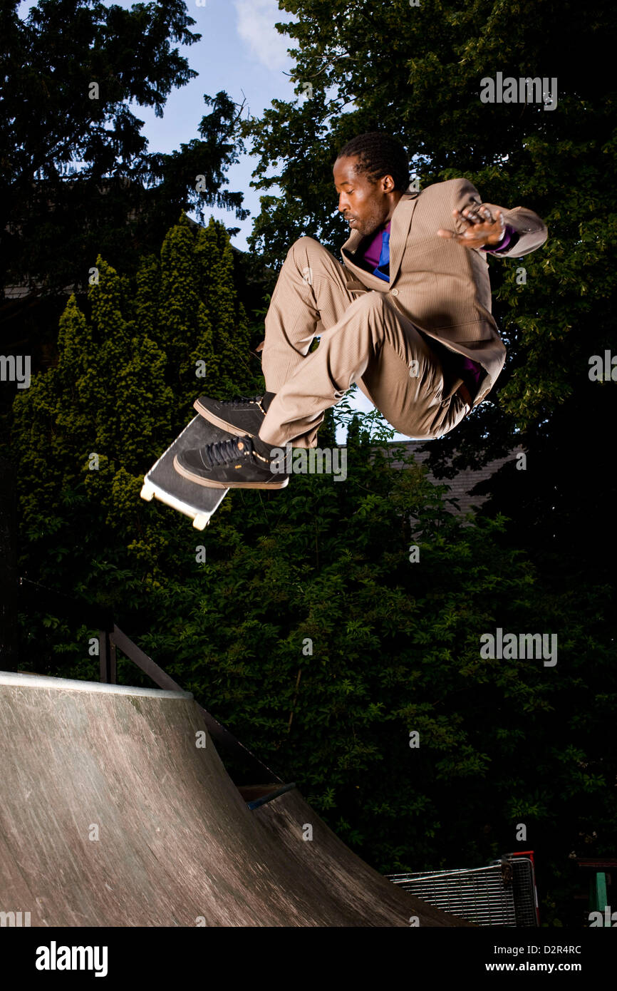 Azione per la corsa su skateboard in un vestito completo, rampa di skate London Foto Stock