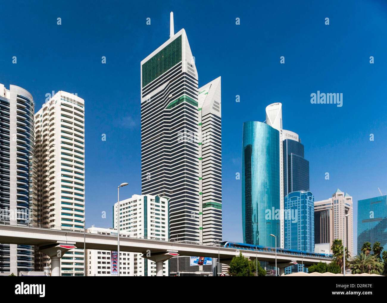 Il Dubai treno Metro in esecuzione nella parte anteriore della Sheikh Zayed Rd, Dubai, UAE Foto Stock