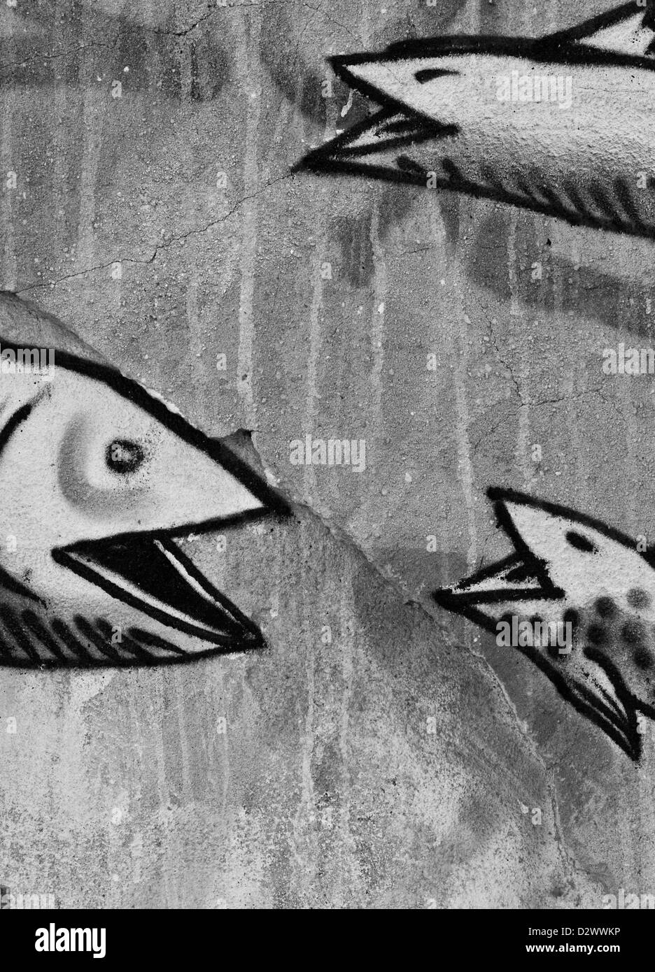 Urban graffiti street art di tre ridere pesce sulla trama di calcestruzzo rotto la parete est di Londra Inghilterra Europa Foto Stock