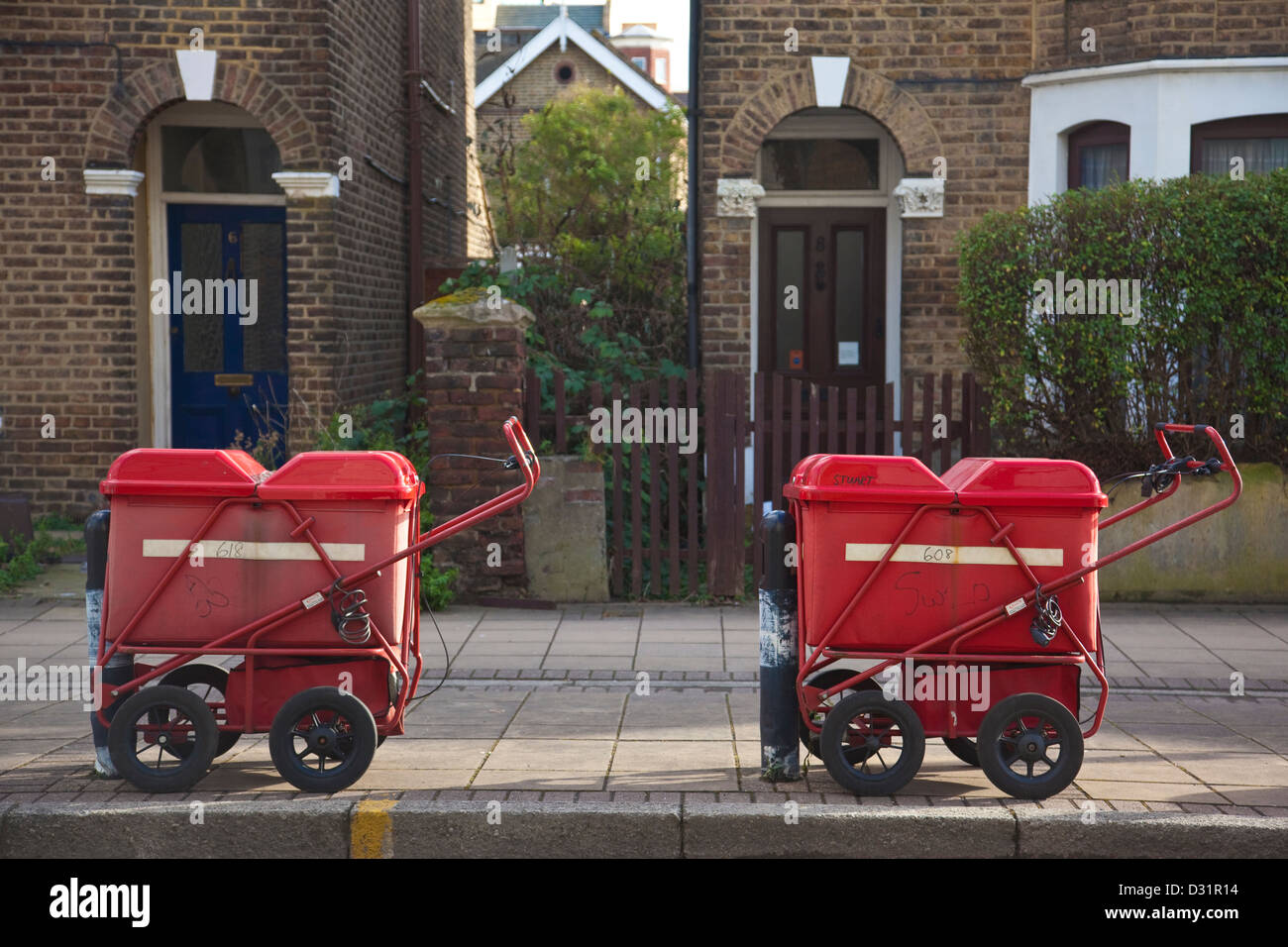 Royal Mail portalettere carrelli parcheggiati sulla strada fuori casa a schiera, England, Regno Unito Foto Stock