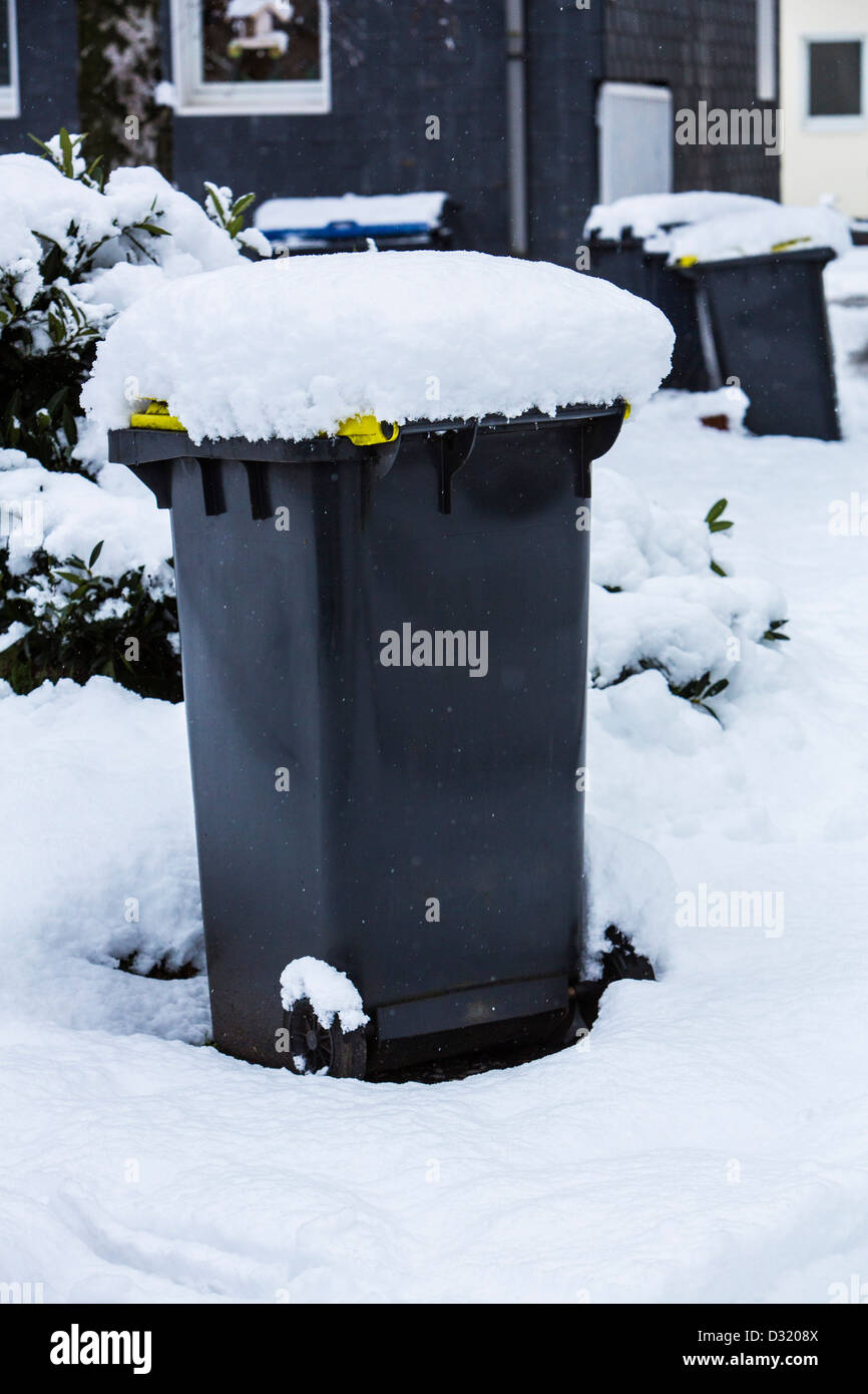 Coperta di neve l'immondizia. A causa di neve pesante l'immondizia non era stato svuotato dalla raccolta differenziata dei rifiuti Servizi. Foto Stock