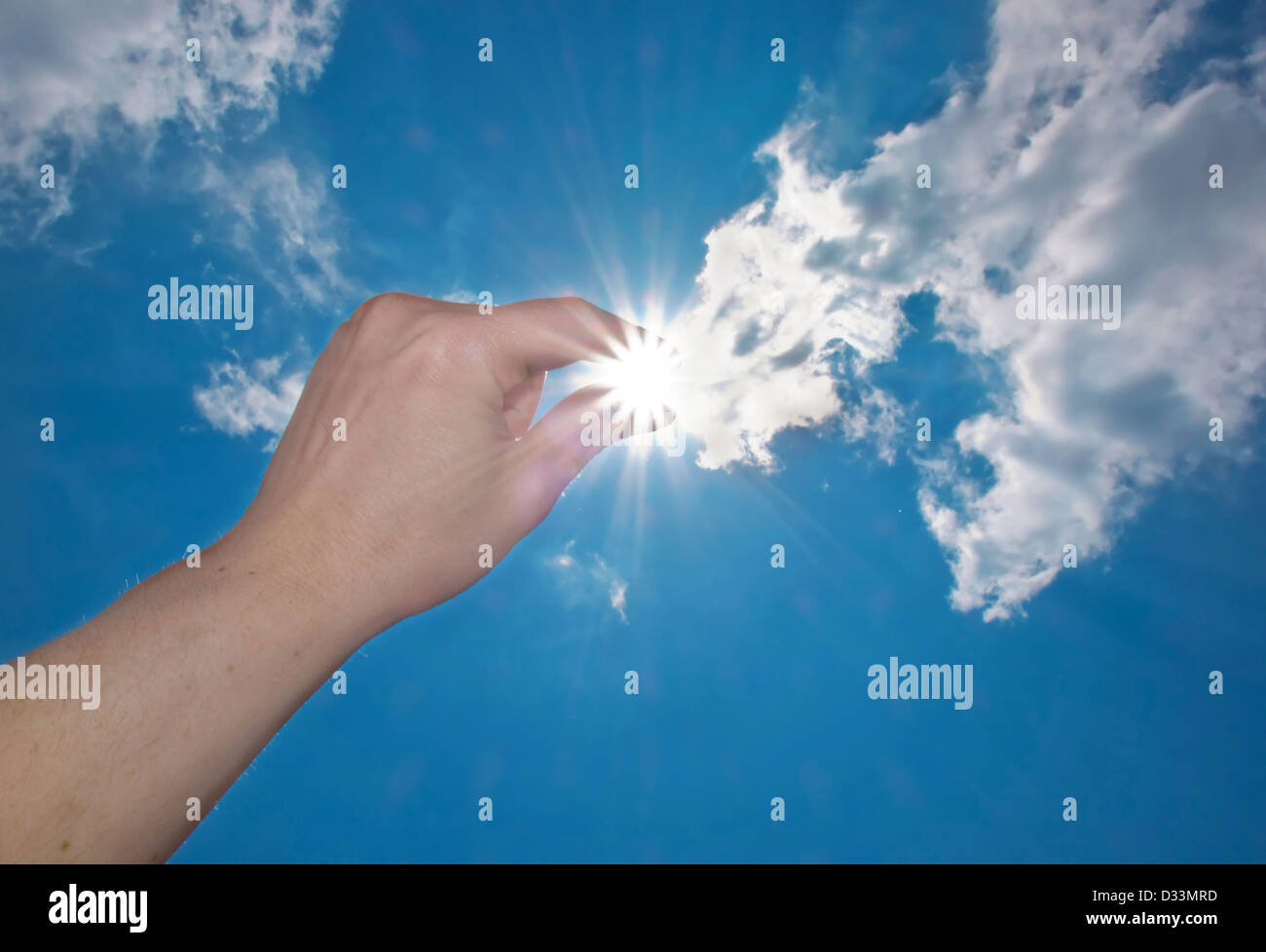La mano di prendere il sole in un cielo blu Foto Stock