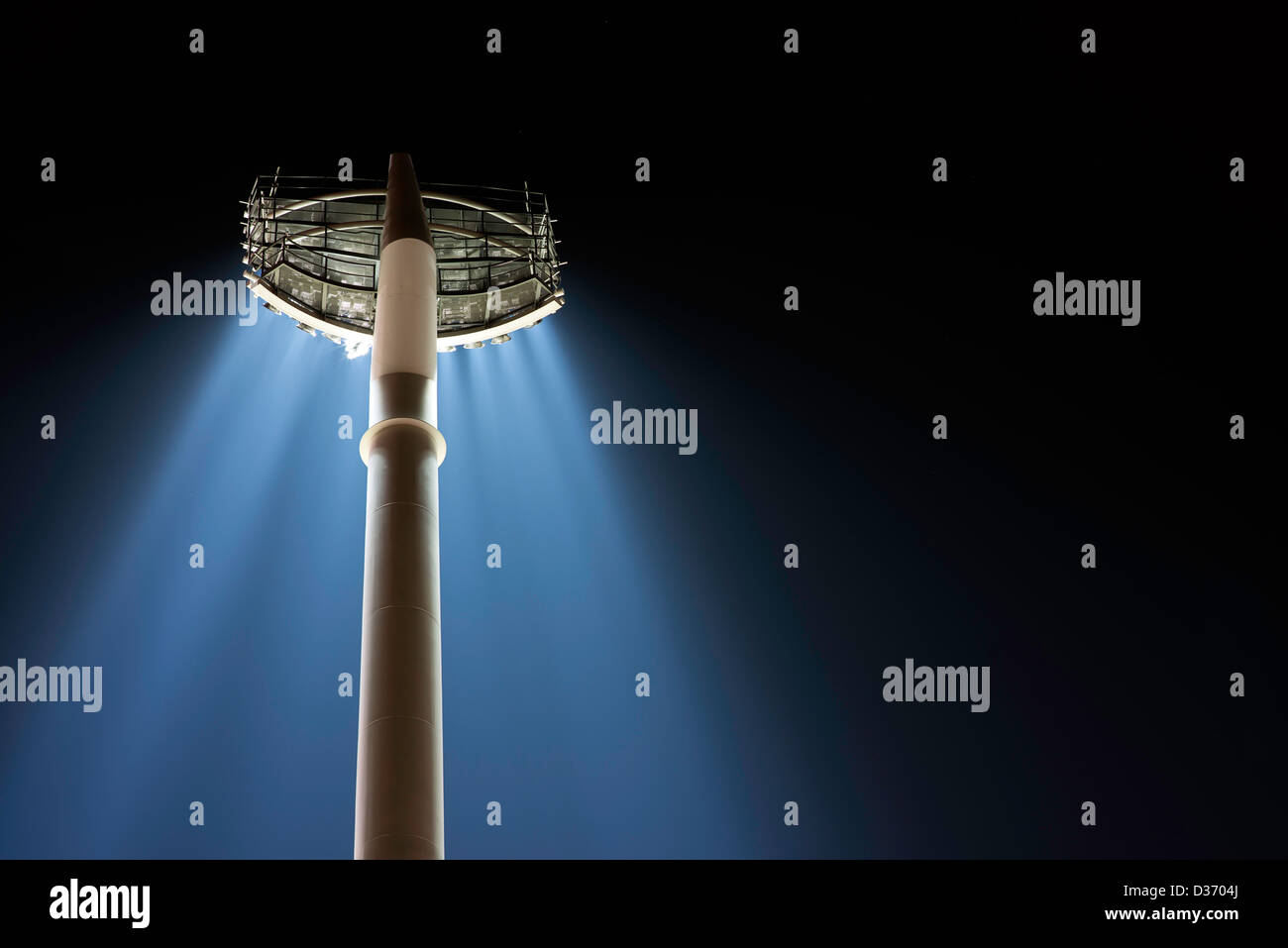 Una vista posteriore dal basso di una grande banca di fari da stadio su un unico palo con loro i washer per trasmissione via IR. Vedere anche verticale. Foto Stock