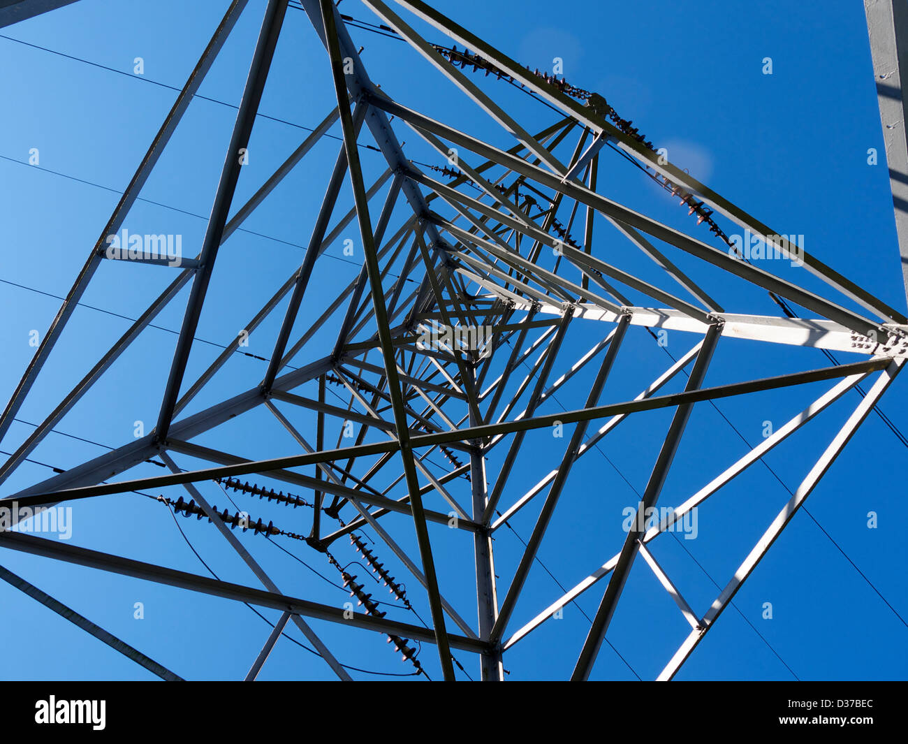 Un traliccio di elettricità contro un cielo blu, girato da sotto Foto Stock