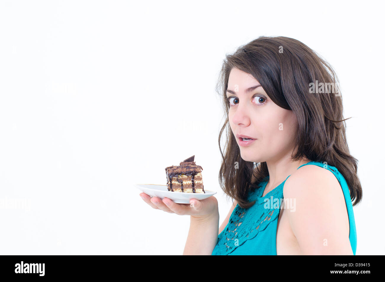 Un wishful ragazza con una deliziosa torta Foto Stock