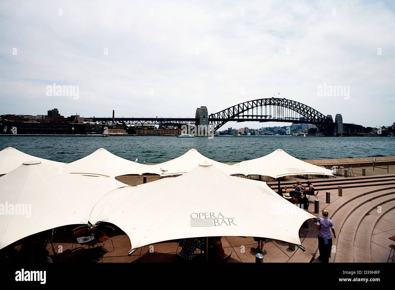 Il Ponte del Porto di Sydney, Sydney, NSW, Australia come vista dalla passeggiata al Sydney Opera House Bar Cafe Foto Stock