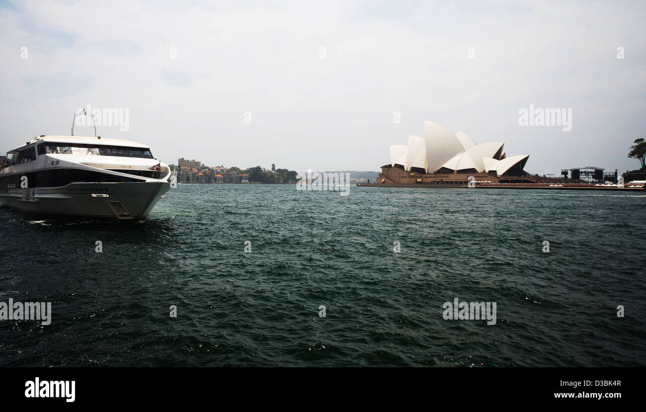 'Sydney Explorer" provenienti da Circular Quay con la Sydney Opera House su un giorno sordo a Sydney Cove. Foto Stock