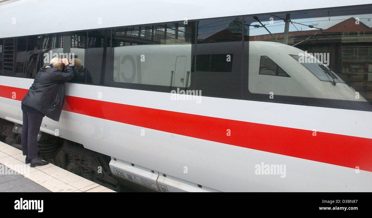 (Dpa) - Una giovane donna guarda in una vettura di un Ghiaccio (Inter City Express) treno ad alta velocità al Bahnhof Zoo stazione ferroviaria di Berlino, 20 maggio 2003. Foto Stock