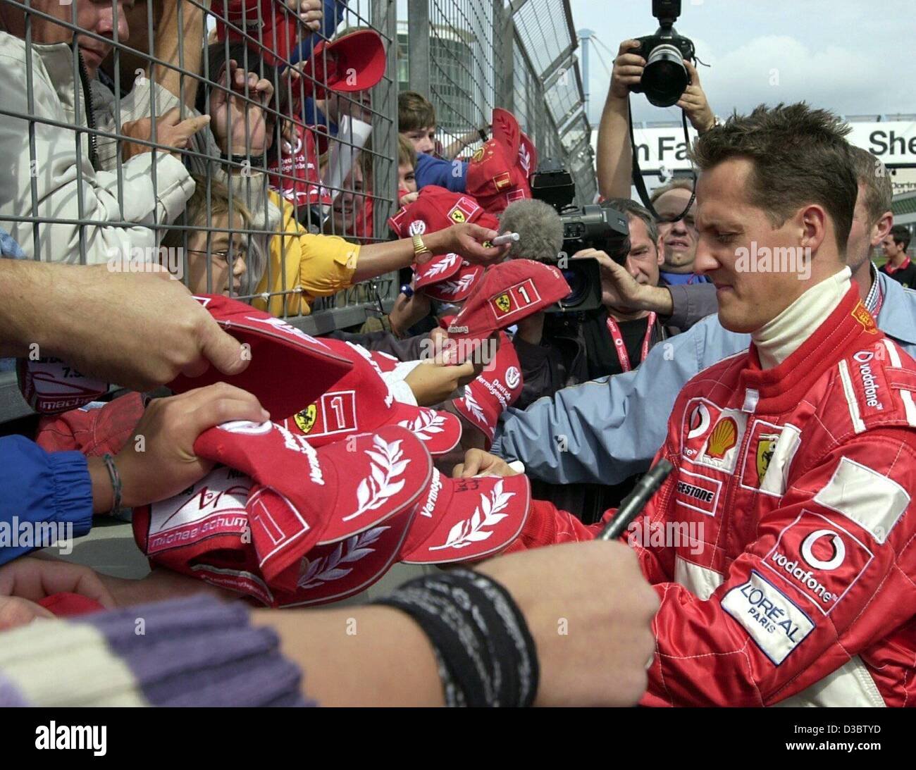 (Dpa) - Tedesco pilota di Formula uno e il campione del mondo Michael Schumacher (Ferrari) firma autografi per i suoi fan al Nuerburgring circuito di formula uno. Il cinque volte vincitore del titolo di campione del mondo richiede un po' di tempo per i suoi fan prima dell'inizio della fase di decidere in gara per il w Foto Stock