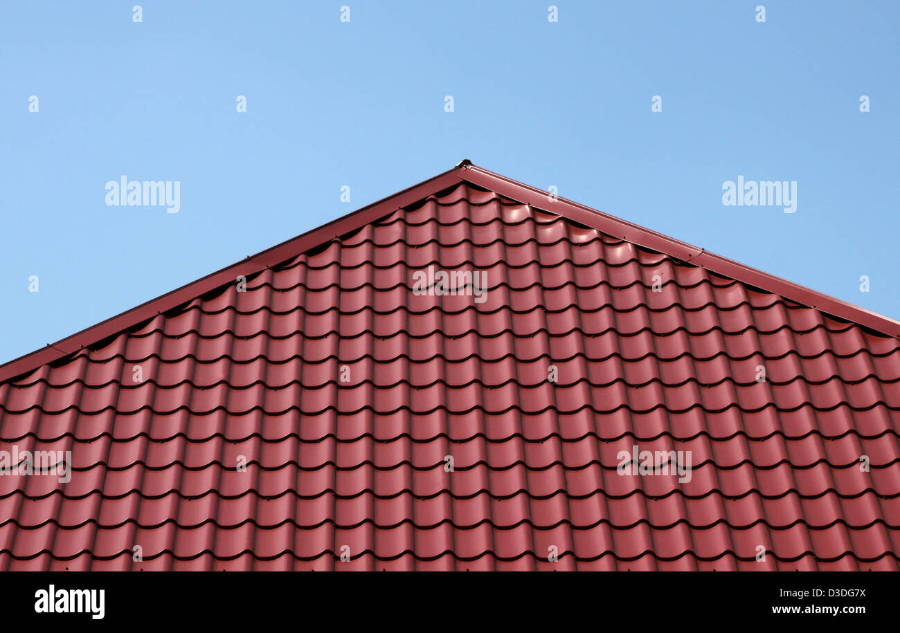 Tetto di tegole rosse e oltre il cielo blu Foto Stock