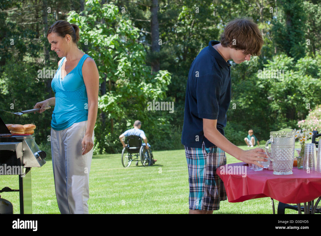 Uomo con lesioni al midollo spinale in carrozzella a picnic in famiglia Foto Stock