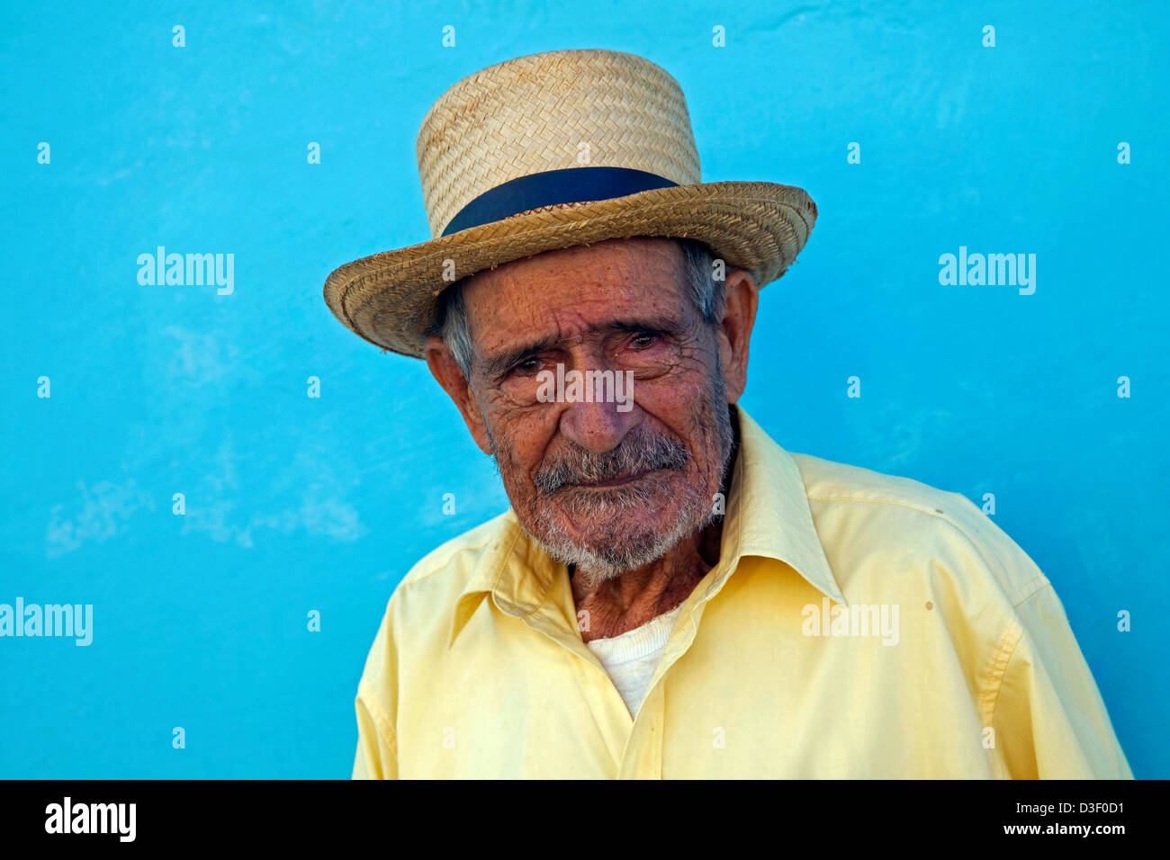 Ritratto di vecchio uomo cubano in posa di fronte di color pastello parete nelle strade di Trinidad, Cuba Foto Stock
