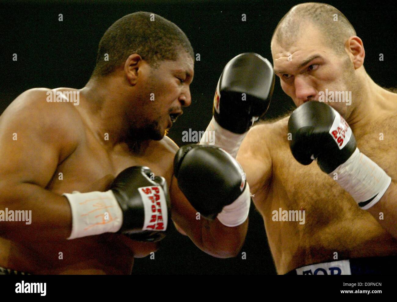 (Dpa) - boxer russo Nikolai Valuev (R) combatte contro di noi Gerald nobili durante il loro WBA heavyweight bout a Kempten, Germania, 20 novembre 2004. Valuev è stato squalificato nel quarto round per colpire ripetutamente nobili sotto la cinghia. Foto Stock