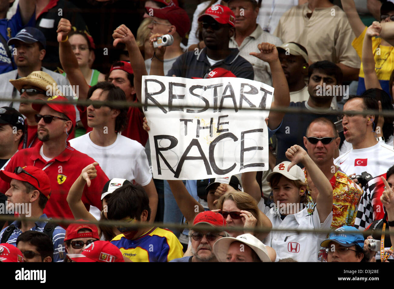 (Dpa) - l'immagine mostra la Formula Uno tifosi protestando con un banner a leggere 'Riavviare la gara' durante un Gran Premio che presentava solo sei vetture in Indianapolis, Stati Uniti d'America, domenica 19 giugno 2005. Tutte e sette le squadre dotate di pneumatici Michelin ha ritirato dalla gara a causa di problemi di sicurezza. Foto Stock